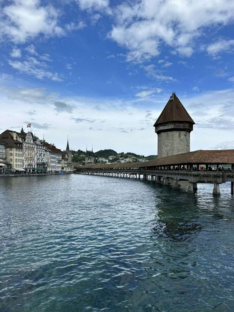 The flower-lined wooden Chapel Bridge and water tower in Lucerne