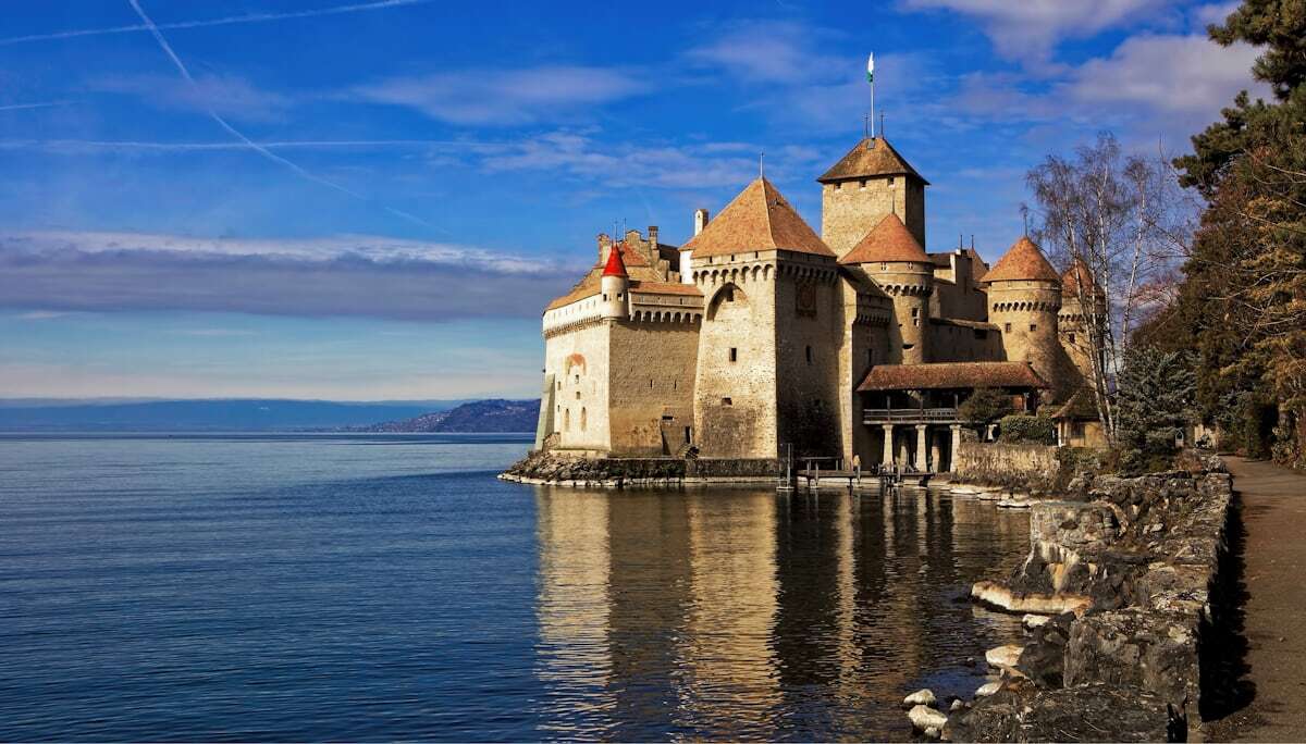 Château de Chillon castle on Lake Geneva with mountains behind