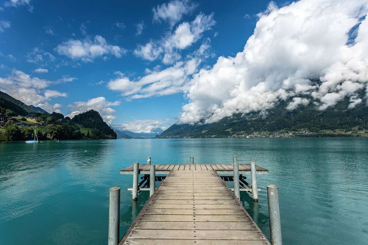 Wooden jetty reaching into the turquoise water of Lake Brienz at Iseltwald