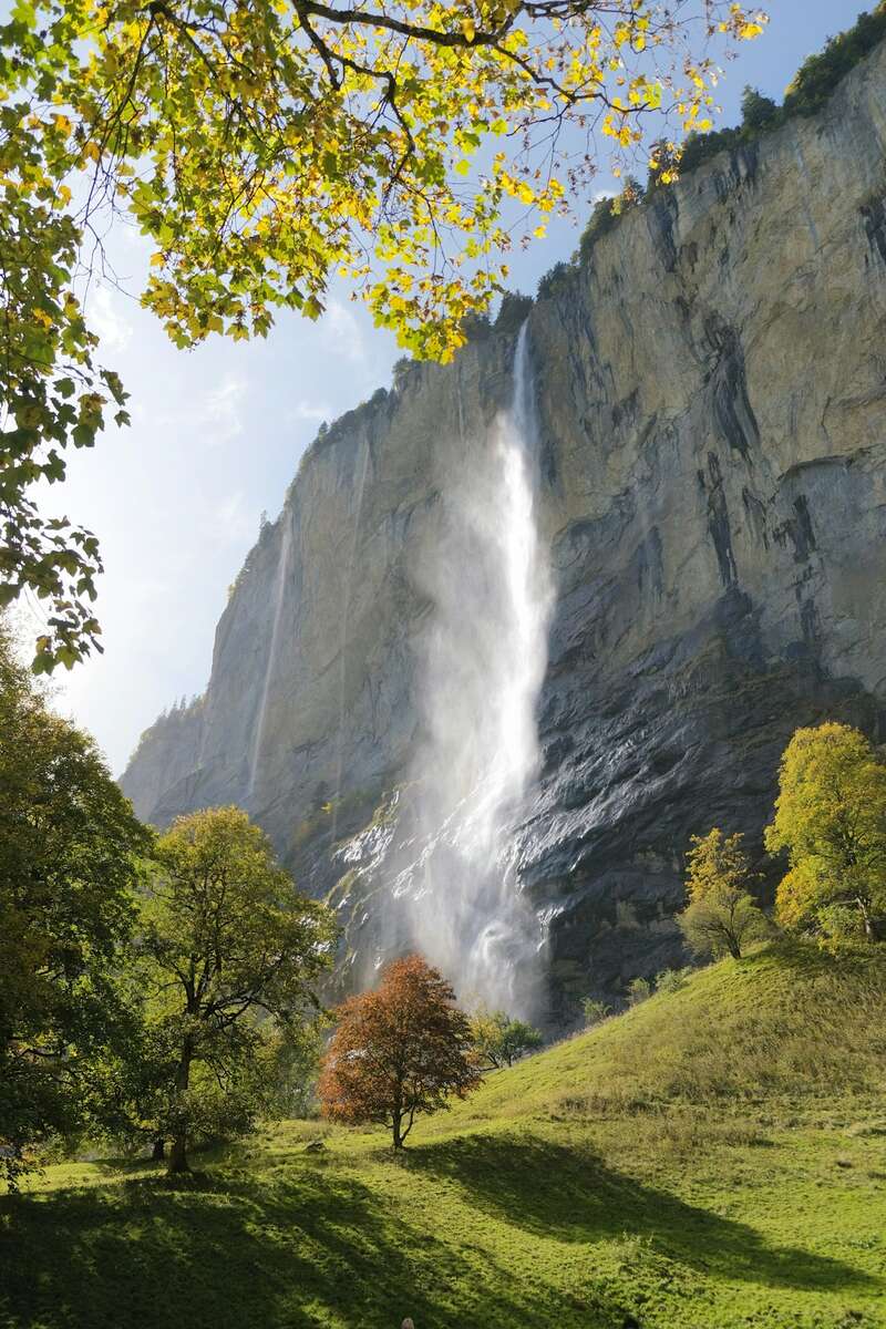 Staubbach Falls tumbling down a cliff above Lauterbrunnen village