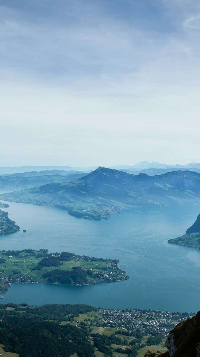 Rolling summit of Mount Rigi surrounded by lakes and Alps