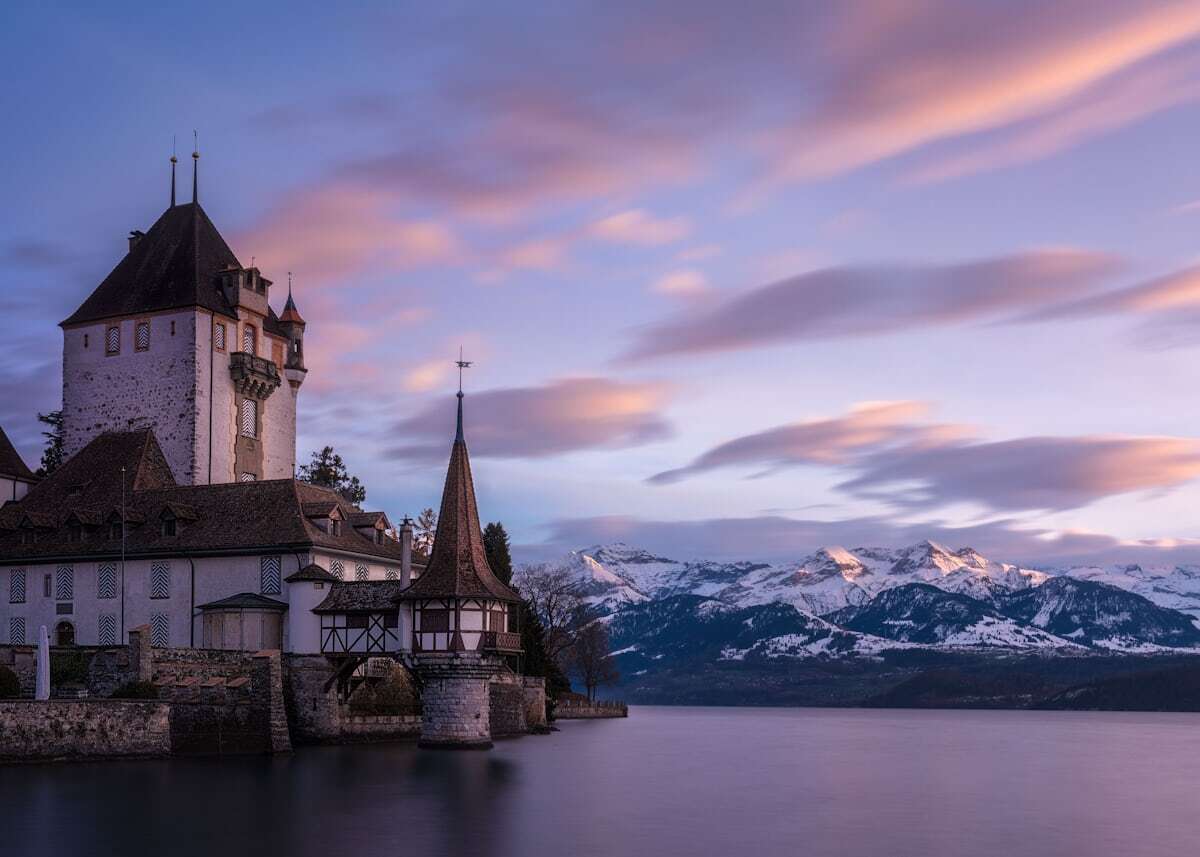 Thun castle above the old town with Lake Thun and Alps behind