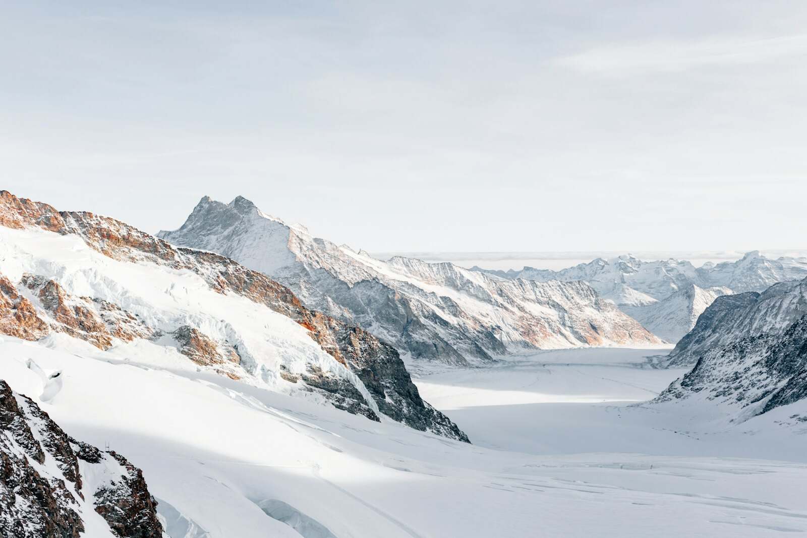 Snow-covered high Alpine peaks under a clear sky