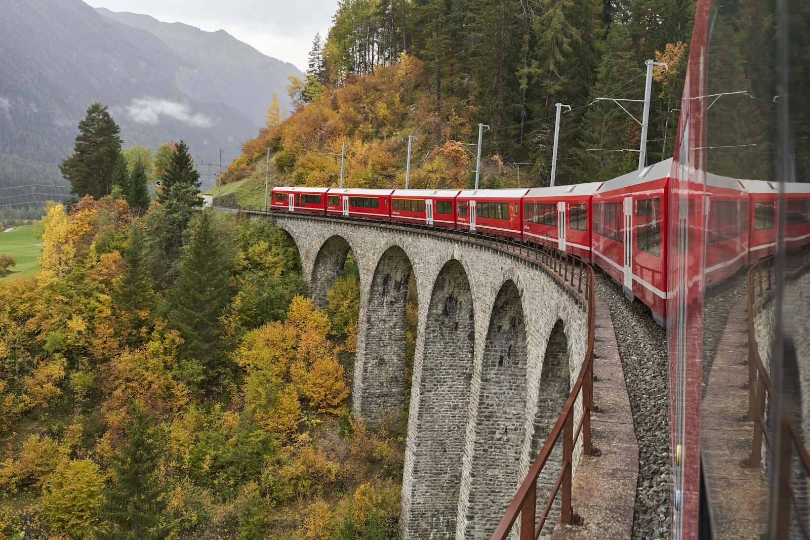 A Swiss train winding through a mountain landscape